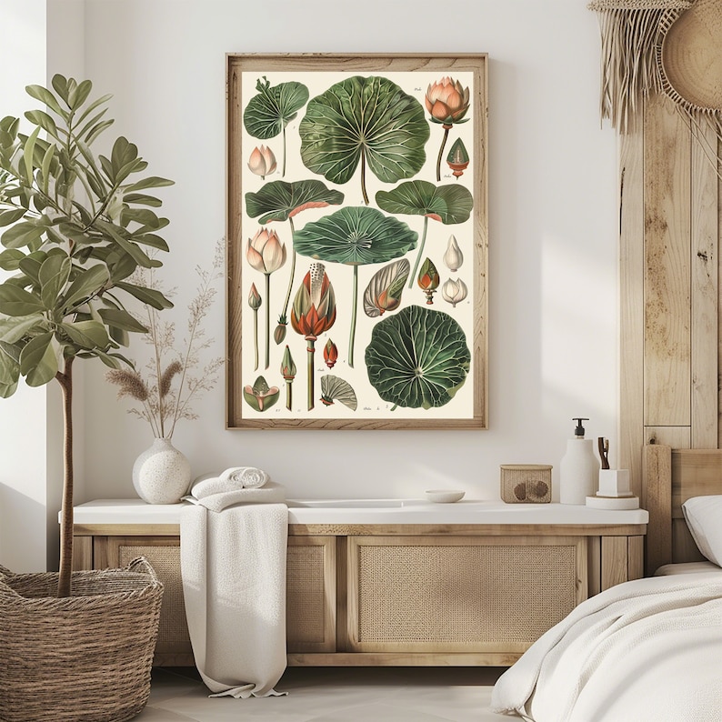 May include: A framed botanical print featuring detailed illustrations of lotus leaves, buds, and flowers in shades of green, orange, and cream. The artwork is set against a neutral background, encased in a light brown wooden frame, and evokes a vintage aesthetic.