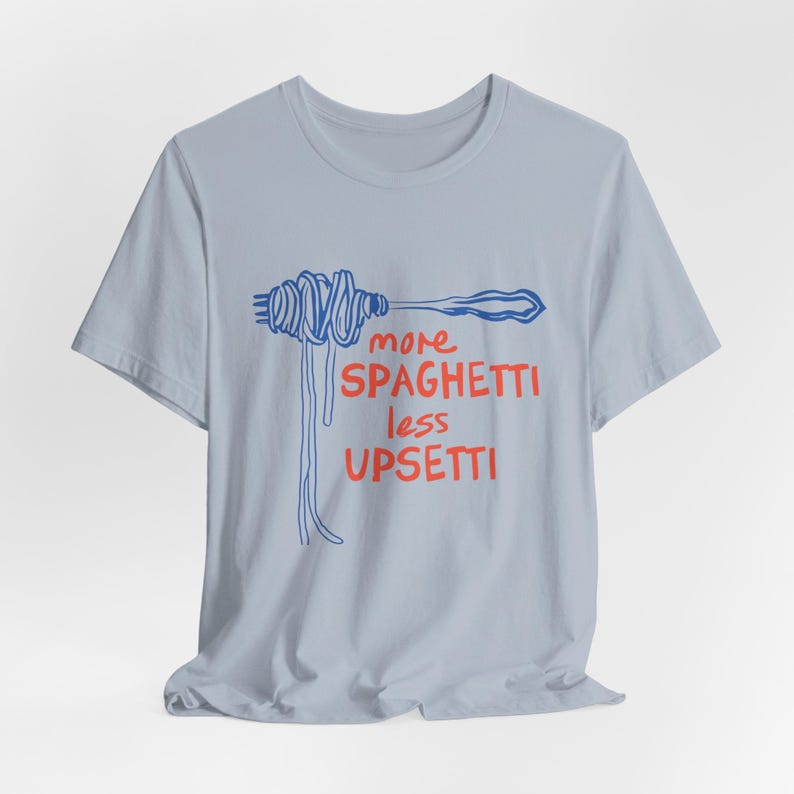 May include: Light blue t-shirt with a blue and red graphic of spaghetti on a fork and the text "more spaghetti less upsetti".
