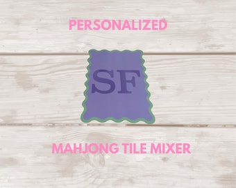 May include: A purple mahjong tile mixer with a scalloped edge and the letters SF printed in the center. The text PERSONALIZED appears above the object, and the text MAHJONG TILE MIXER appears below it. The logo SGfts is in the bottom corner.