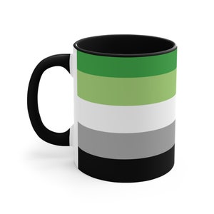 May include: White ceramic mug with a black handle and interior. The exterior features a horizontal striped design in shades of green, white, grey, and black, representing the aromantic pride flag. A simple and stylish design.