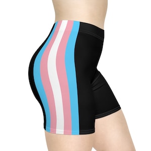 May include: Black athletic shorts with a white, pink, and blue stripe down the side. The stripe is a representation of the transgender pride flag.