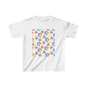 May include: White t-shirt with a rainbow bee and flower pattern.