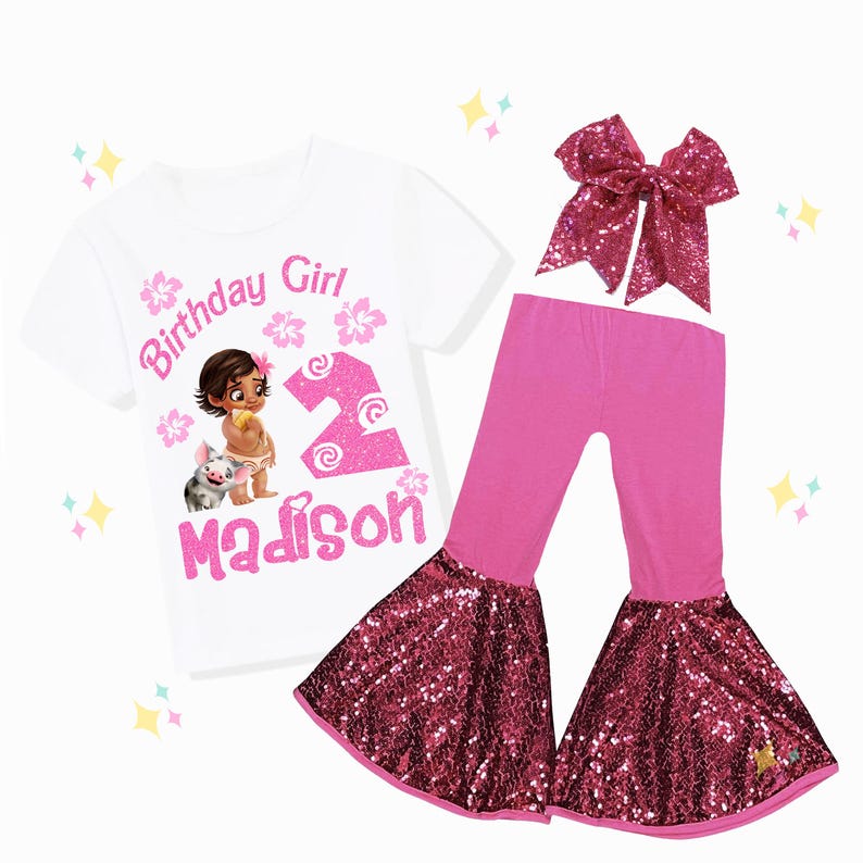 May include: A white t-shirt with a graphic of a cartoon girl and piglet, the text "Birthday Girl", the number "2", and the name "Madison" in pink. The outfit includes pink pants with sequined bell bottoms and a matching sequined bow.