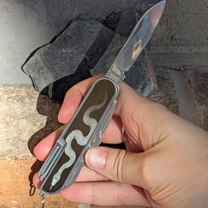 pocket knife with a snake design