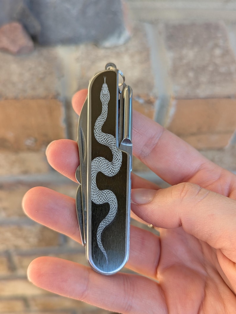 snake engraved utility knife