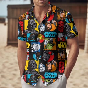 May include: A black button-up shirt with a short sleeve featuring a repeating pattern of Star Wars characters and the text "Star Wars".