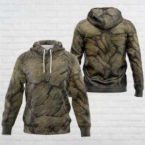 May include: A green and brown camouflage hoodie with a drawstring hood. The hoodie has a front pocket and long sleeves.