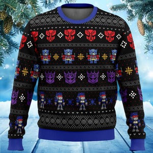May include: Black long-sleeved jumper with a blue crew neck and cuffs. The jumper features a repeating pattern of red and purple robot faces, blue robots, and snowflakes. A festive holiday design.