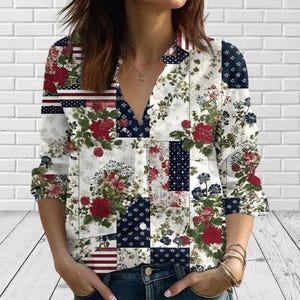 May include: A long-sleeved button-down shirt featuring a patchwork design of floral patterns in red, white, and dark blue. The garment includes sections with red and white stripes, dark blue polka dots, and various botanical prints with red flowers.