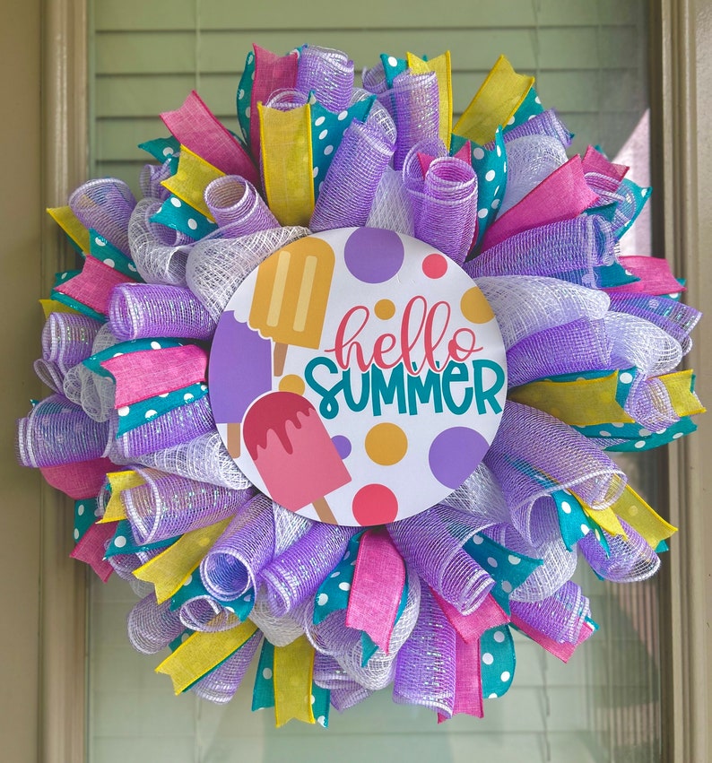 May include: A purple, white, pink, and yellow wreath with a round sign that says "hello summer" and has ice cream cones on it.