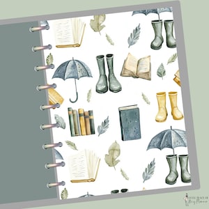May include: A planner insert featuring a repeating pattern of watercolor illustrations. The design includes open books, umbrellas, rain boots, and leaves in shades of gray, beige, and yellow. The insert is bound with silver rings and has a gray cover.