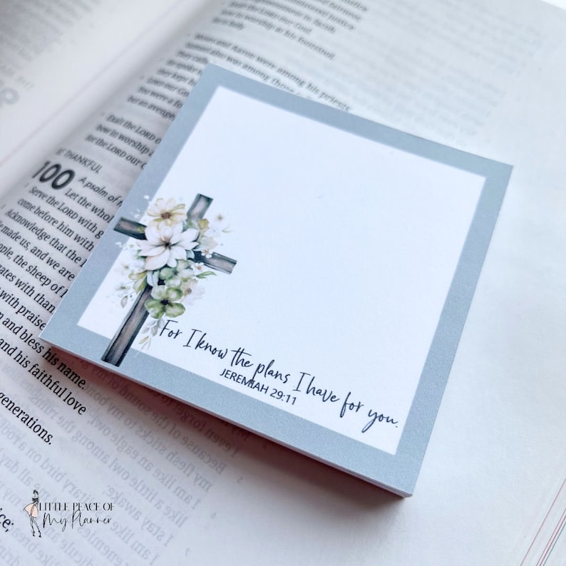 May include: A white and gray floral cross with the text "For I know the plans I have for you. Jeremiah 29:11" on a light blue background.