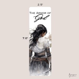 May include: A bookmark featuring a woman in a white shirt and brown leather armor, holding a sword and a white rose. The text "The Armor of God" is written in black cursive at the top of the bookmark.