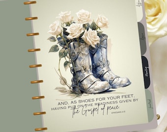 May include: A planner with a green cover and gold rings. The cover features a watercolor illustration of white roses and blue cowboy boots. The text "AND, AS SHOES FOR YOUR FEET, HAVING PUT ON THE READINESS GIVEN BY THE GOSPEL OF PEACE. EPHESIANS 6:15" is printed on the cover.