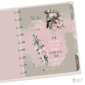 May include: A pink and gray planner with a floral design and inspirational quotes. The quotes are "Take the helmet of salvation and" and "The sword of the spirit, which is the word of God." Ephesians 6:17.