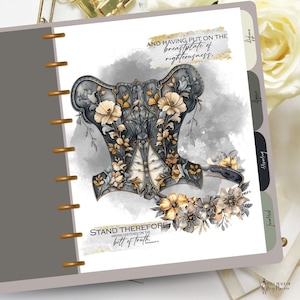May include: A gray and gold corset with floral details and a quote that reads "Stand therefore, having fastened on the belt of truth."