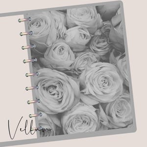 May include: A grayscale notebook with a floral rose design. The notebook features a spiral binding on the left side and the word "Vellum" in cursive script. The background is a light beige color.