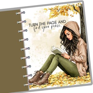 May include: An illustration of a woman reading a book under a tree with autumn leaves. She wears a tan hooded jacket, green pants, and brown boots. The text reads "Turn the page and find your peace."