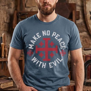 May include: A blue short-sleeved t-shirt featuring a large red Jerusalem cross centered on the chest. The text "MAKE NO PEACE WITH EVIL" is printed in white capital letters in a circular pattern around the cross design on the front of the shirt.