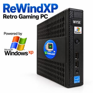 May include: A black compact desktop computer labeled ReWindXP Retro Gaming PC. The front panel features a WYSE logo, a Windows XP badge, a power button, two USB ports, and an Energy Star sticker. A circular ReWindXP logo is centered.