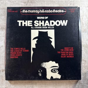 May include: Vintage "More of The Shadow" 3-record set. The album cover is black with white text and a silhouette of a man in a hat. The album features Orson Welles. The album's titles include "The Temple Bells" and "Society of the Living Dead."