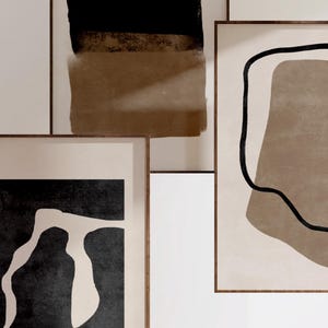 May include: Three framed abstract art prints with brown and black geometric shapes and lines on a white background.