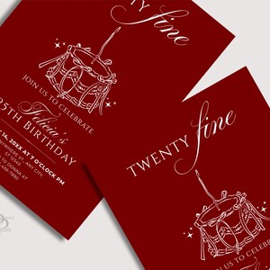 May include: Burgundy-colored birthday invitations with white script and illustrations. The design includes a drum illustration, the words "Twenty Fine", and details for a 25th birthday celebration, including the name "Felicia's".