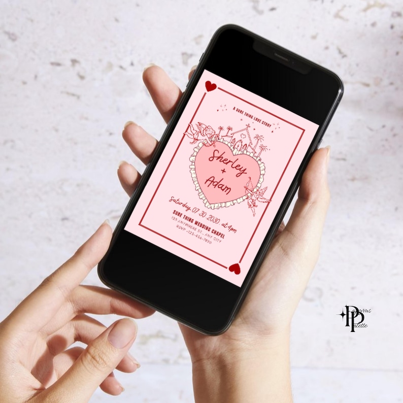 May include: A smartphone displays a pink wedding invitation with a heart-shaped design. The invitation includes the names "Sherley + Adam", event details, and decorative elements. Two small red hearts are at the top and bottom.