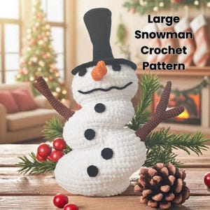 May include: A handmade, white crochet snowman with a black top hat, black eyes, and a carrot nose. The snowman has brown stick arms and black buttons. The image includes the text "Large Snowman Crochet Pattern".