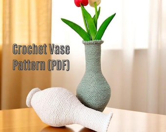 May include: Two crocheted vases, one white and one green, with a bouquet of red and white flowers. Crochet Vase Pattern (PDF) is written on the image.