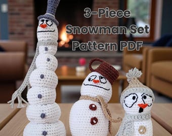May include: A 3-Piece Snowman Set Pattern PDF featuring three crocheted snowmen. The tallest snowman wears a gray top hat and scarf. The middle snowman has a brown hat and scarf. The smallest snowman wears a beige pom-pom hat and scarf.
