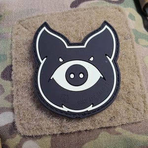 May include: Black and white pig patch with a single eye and the text "Come and Take It".