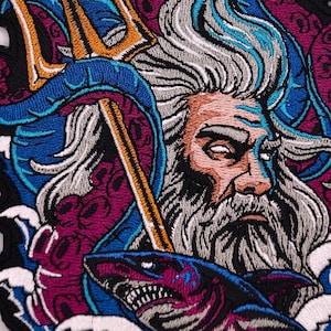 May include: Embroidered patch featuring a detailed illustration of a bearded figure with a trident, surrounded by blue and purple elements, and a shark. The design incorporates shades of orange, white, and black, creating a striking visual effect. The patch is likely for jackets, bags, or other apparel.