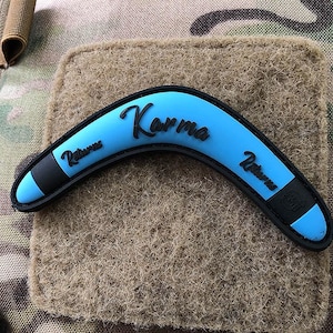 May include: A blue boomerang with black trim and the word "Karma" printed on it.