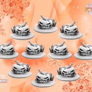 May include: Ten white ceramic jack-o'-lantern candle holders with a carved face and a leafy stem. The candle holders are arranged in a grid pattern on a peach-coloured background with floral designs.