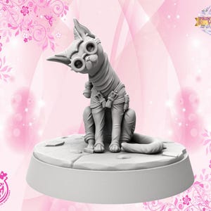 May include: A grey cat figurine, wearing steampunk goggles and clothing, sits on a round base. The cat has a tilted head, and the base has a textured surface. The background is pink with floral and butterfly designs.