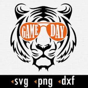 Puede incluir: Silueta en blanco y negro de un tigre con gafas de sol naranjas que dicen "GAME DAY".