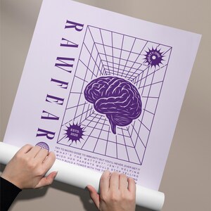 May include: A purple and white poster with the word "RAWFEAR" vertically on the left side. The poster features a brain graphic, a grid, and the text "ESTD. 2025". The poster is being held by a person.