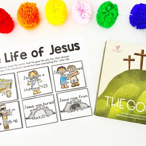 May include: A children's educational set featuring a book titled "The Gospel" and a visual aid titled "The Life of Jesus." The book cover depicts three crosses on a green hill. The visual aid includes illustrated panels with Bible verses.