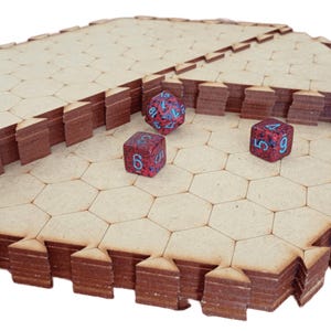May include: A modular, hexagonal game board made of light brown wood, with stacked edges and three multi-sided dice. The dice are red with blue numbers. The board is designed for tabletop gaming.