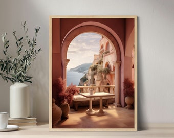 May include: A framed print of a pink arched doorway overlooking a coastal town with a table and chairs on the balcony. The view from the balcony shows a blue ocean and a green hillside.