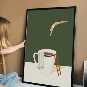 May include: A framed illustration of a person diving into a large coffee mug. The mug has a white background with a blue stripe and a brown liquid inside. A white towel hangs on the side of the mug and a wooden ladder is next to it. The background is a dark green color.