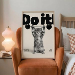 May include: A framed print featuring a kitten lifting a barbell, with the bold text "Do it!" above. The image is in black and white, with additional text at the bottom that reads "Even cats are stronger than your excuses" and "Do it... or don't... whatever."
