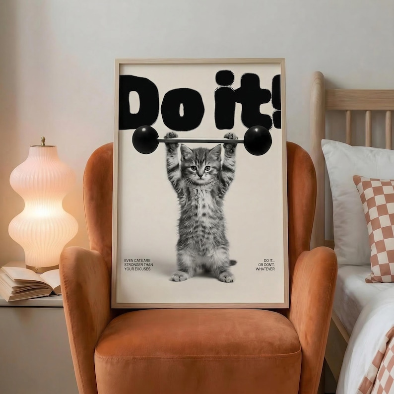 May include: A framed print featuring a kitten lifting a barbell, with the bold text "Do it!" above. The image is in black and white, with additional text at the bottom that reads "Even cats are stronger than your excuses" and "Do it... or don't... whatever."