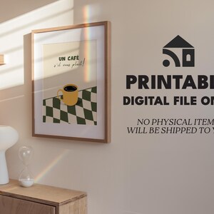 May include: Printable digital file of a retro-style illustration of a cup of coffee with the text "UN CAF&Eacute; s'il vous plait!" in a brown frame on a white wall.