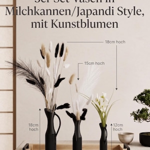 Könnte beinhalten: Ein Set aus drei schwarzen Vasen mit Kunstblumen. Die größte Vase ist 18 cm hoch, die mittlere 15 cm und die kleinste 12 cm. Der Text auf dem Bild lautet "3er Set Vasen in Milchkannen/Japandi Style, mit Kunstblumen."
