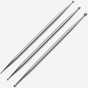 May include: Three silver metal tools with rounded tips of different sizes. The tools are used for crafting and art projects.