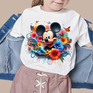 May include: White t-shirt with a colorful graphic of Mickey Mouse surrounded by flowers and water droplets.