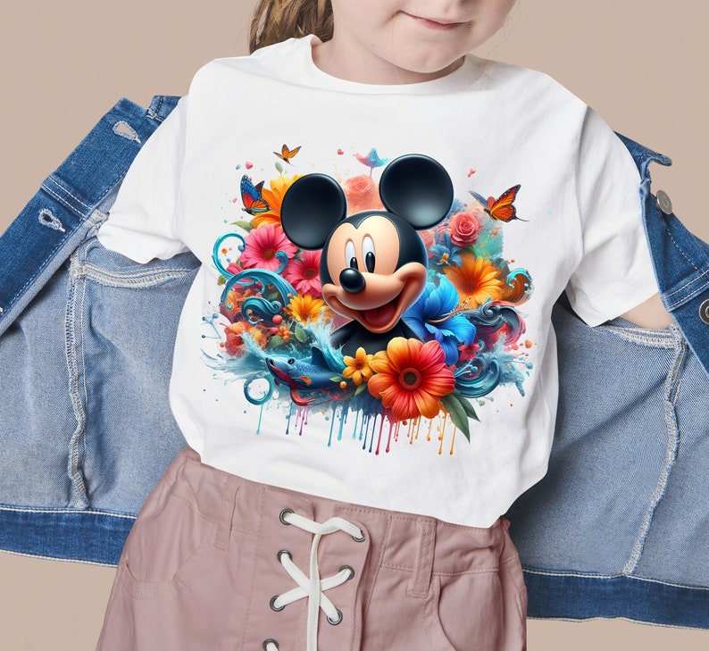 May include: White t-shirt with a colorful graphic of Mickey Mouse surrounded by flowers and water droplets.