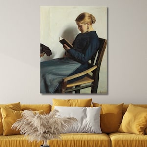 May include: A painting of a woman sitting in a chair and reading a book. She is wearing a blue dress and has blonde hair. The painting is set against a white background.